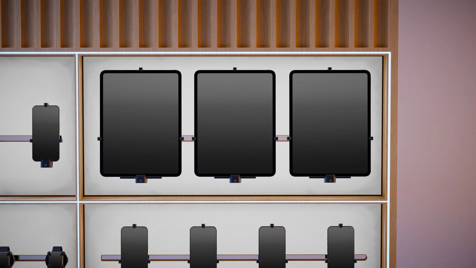 Frame from the OnePOD Max film: a retail wall of tablets and phones on OnePOD Max mounts